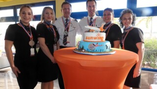 Sunwing crew posing at inaugural flight