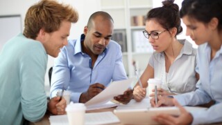 Young business people meeting around table